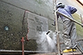 a ships hull is cleaned to the bare metal with 2500 bars working pressure